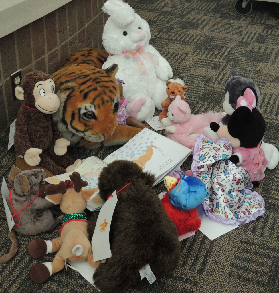 Stuffed Tiger reading to other stuffed animals